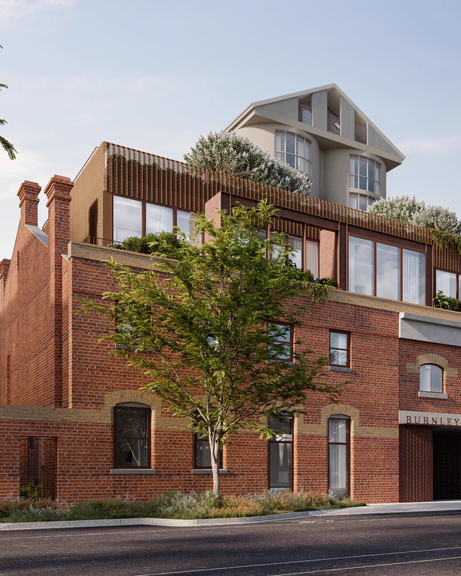 Terrace homes rising above the heritage brickwork on Burnley Street