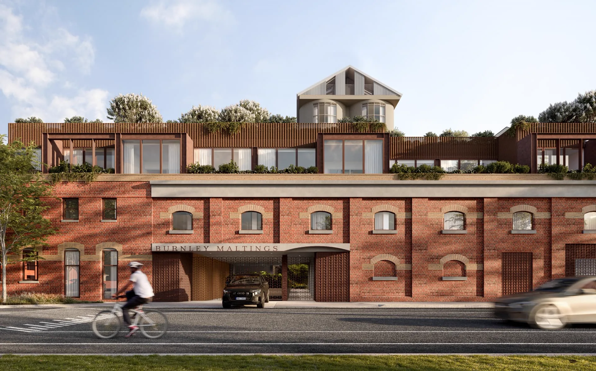 The restored Burnley Maltings brick frontage with contemporary rooftop residences